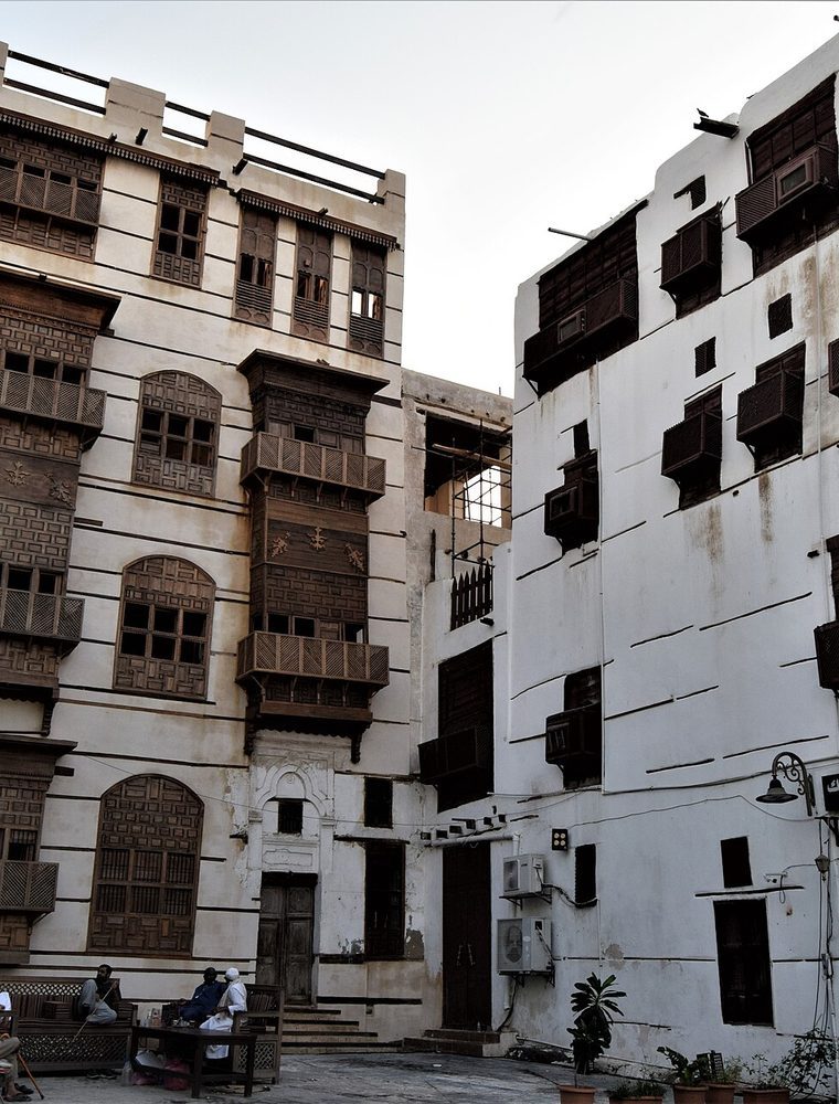 Traditional coral-stone houses with carved wooden balconies in historic Jeddah.